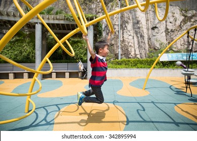 young boy climbing on monkey bars - Powered by Shutterstock