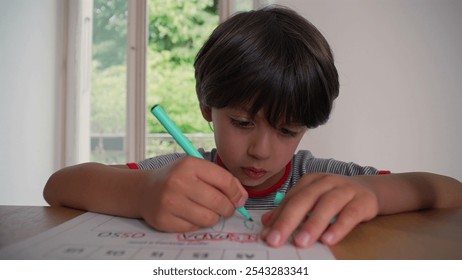 Young boy concentrating on coloring a worksheet, holding a pen with precision and focus, engaged in a quiet artistic task, creating a drawing in a calm and peaceful home setting - Powered by Shutterstock