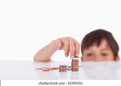 Young Boy Counting His Change Against A White Background