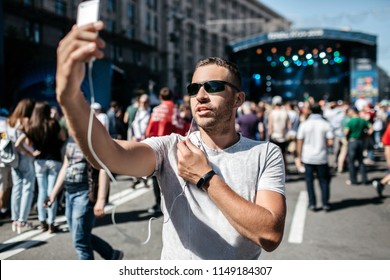 A Young Boy Is A Coverage Of A Sporting Event, Or A Concert. A Blogger Is Using A Smartphone To Go Live. A Journalist Is A Calling