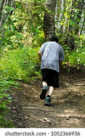 A Young Boy Cross Country Running Uphill