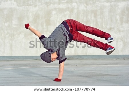Young boy dancing break dance on the street