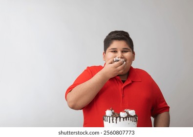 Young boy devouring the cake with his hands(Obesity)