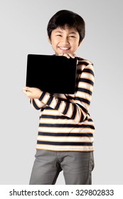 Young boy with digital tablet, Isolated on grey background