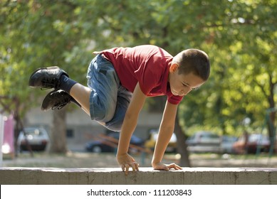 Young Boy Doing Parkour Exercise  Jumping Over Wall