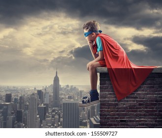 A young boy dreams of becoming a superhero. - Powered by Shutterstock