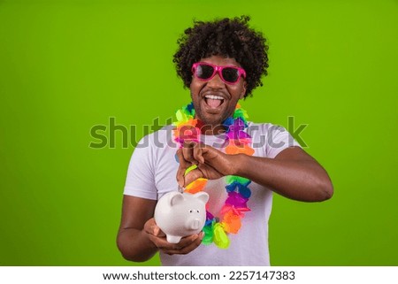 young boy dressed for carnival holding a piggy bank