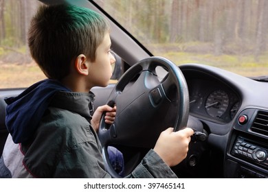 Young Boy Driving A Car