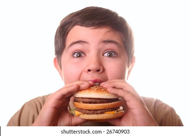 Young boy eating hamburger