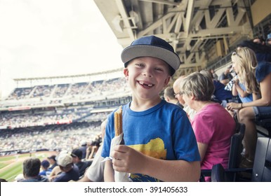 Young Boy Enjoying A Day Watching A Professional Baseball Game