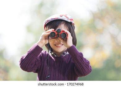 Young boy exploring by looking through binocular