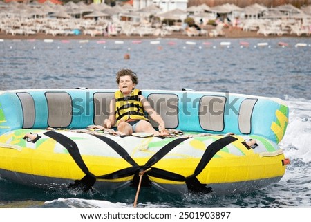 Similar – Image, Stock Photo A young boy exudes confidence with his hands on his hips, wearing a high-tech visor, ready to enjoy a kids party