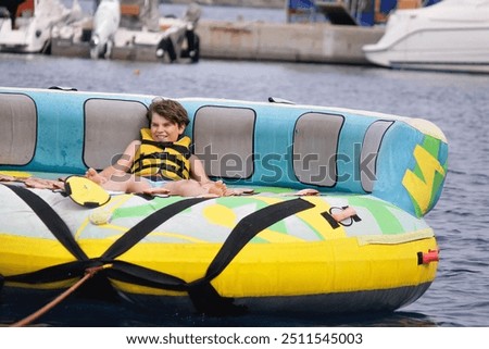 Similar – Image, Stock Photo A young boy exudes confidence with his hands on his hips, wearing a high-tech visor, ready to enjoy a kids party