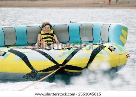 Similar – Image, Stock Photo A young boy exudes confidence with his hands on his hips, wearing a high-tech visor, ready to enjoy a kids party