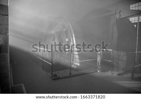 Young boy facing big chapel window and lifting arm with sunrays and fog