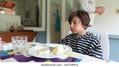 
Young Boy Feeling Satiated During Lunch