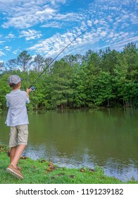 Young Boy Fishing Alone During Summer