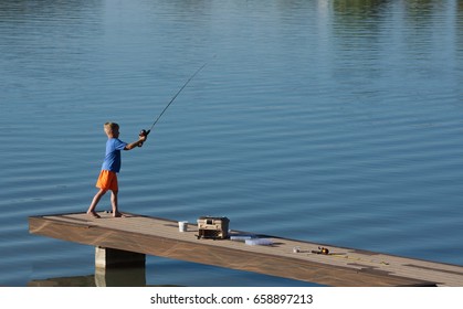 Young Boy Fishing Off Dock