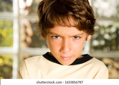 Young boy frowning, well lit - Shutterstock ID 1655856787