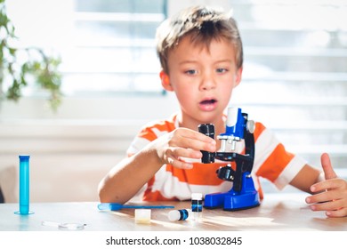 young boy is frustrated while working with the microscope at home