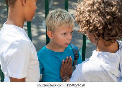 Young Boy Getting Bullied By Two Older Kids At School