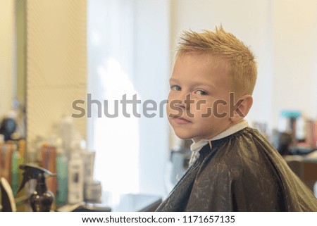 Similar – Beautiful boy getting a haircut with scissors