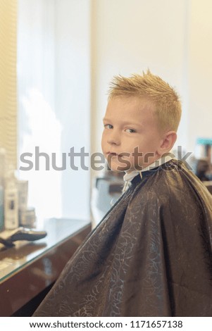 Similar – Beautiful boy getting a haircut with scissors