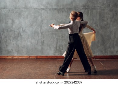 Young Boy And Girl Dancing Ballroom Dance Viennese Waltz.