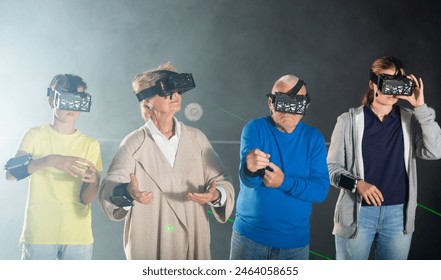 Young boy and girl with their grandparents wearing VR headsets and playing games. - Powered by Shutterstock