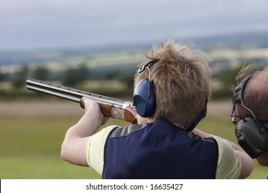Young boy given advice on  clay pigeon shooting