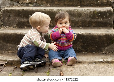 Young Boy Giving Sad Baby Girl A Hug