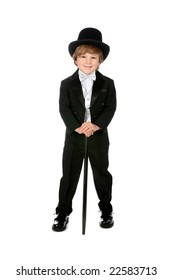 young boy grinning and wearing his black tuxedo