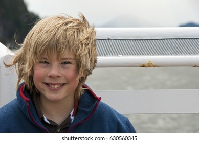 Young Boy With Hair Blowing In Wind.