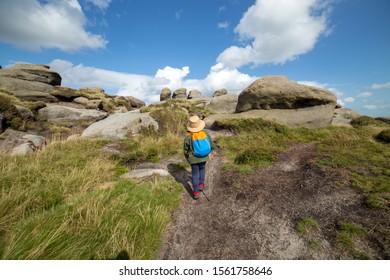 Young Boy Hiking On The Path Through The Weathered Gritsone Boulders, Kinder Scout, Edale, Peak District, England, UK