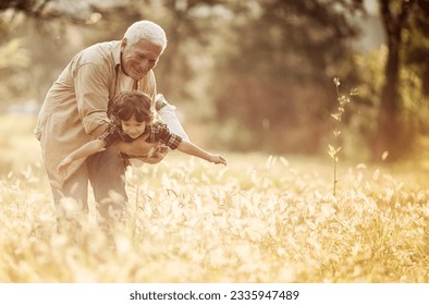 Young boy and his grandfather spending time at the park forest - Powered by Shutterstock