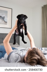 Young Boy With His New Puppy