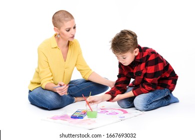 Young Boy And His Therapist In Child Occupational Therapy Session Painting With Watercolors. Child Art Therapy Concept On White Background.