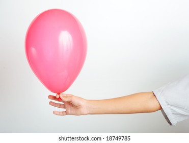 Young Boy Holding A Red Balloon With Hand