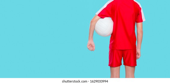 Young boy Holding Volleyball. Isolated On Blue