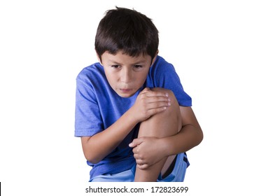 Young Boy Holds His Sore Knee - On White Background