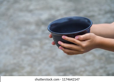 Young Boy Homeless Holding Ceramic Plate With Hungry And Need Food. Homeless Concept. 