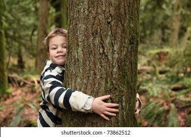 Young Boy Hugging A Tree