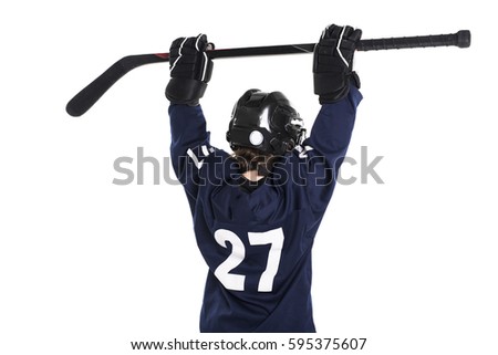 A Young boy in ice hockey gear against white