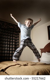 Young Boy Jumping On The Bed