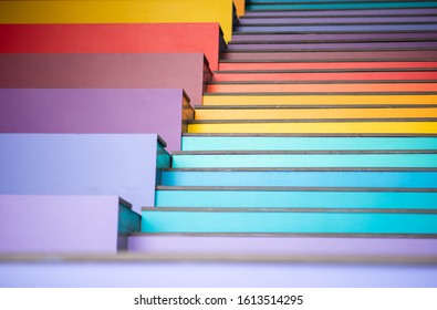 Young boy jumping on the stair rainbow colorful