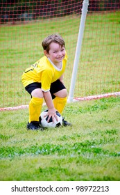 Young Boy Or Kid Playing Soccer Goalie