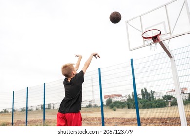 Young Boy Kid Shooting A Basketball In The Hoop