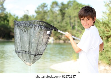 Young Boy With A Large Fishing Net