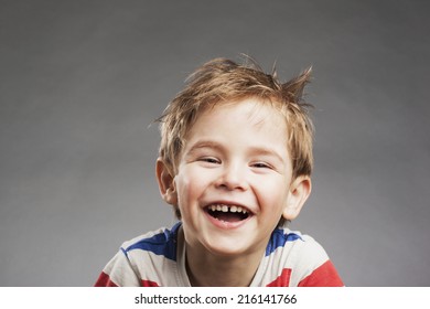 Young Boy Laughing Against Gray Background Stock Photo 216141766 ...