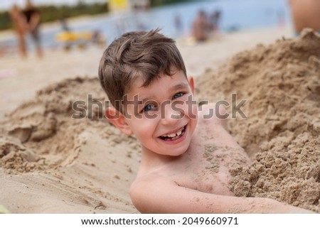 Similar – Image, Stock Photo Small child buried in the sand of the beach